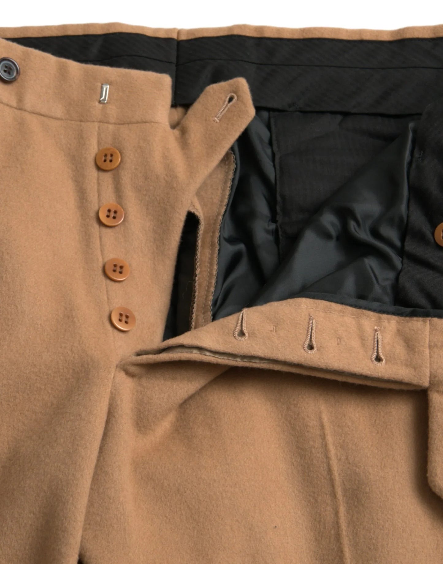 Close-up of tan wool pants with brown buttons and black lining at ONJEL Fashion Boutique