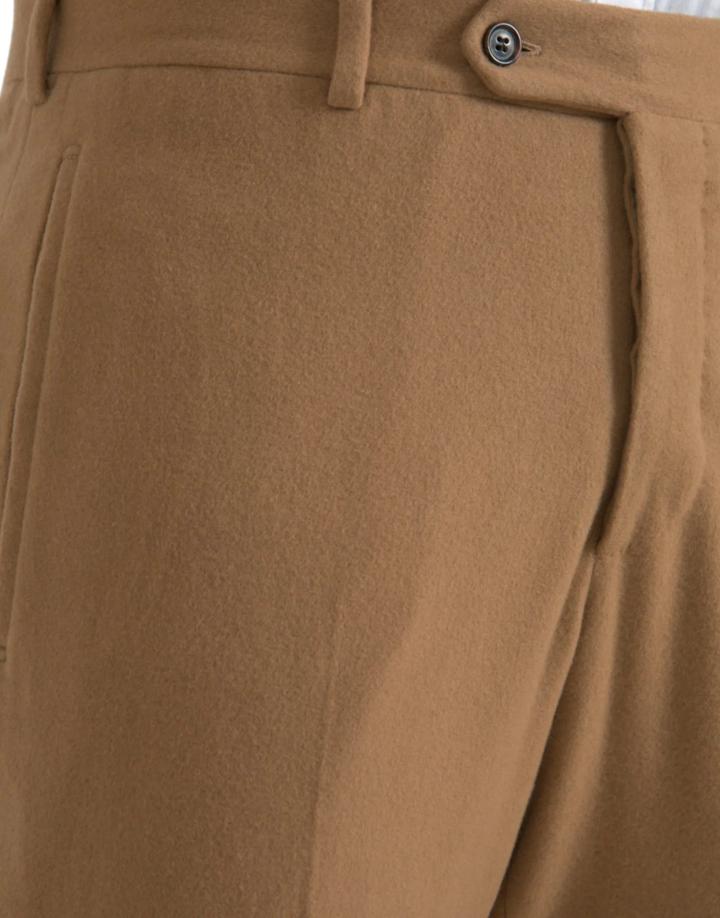 Close-up of tailored camel wool trousers with button detail at ONJEL Fashion Boutique