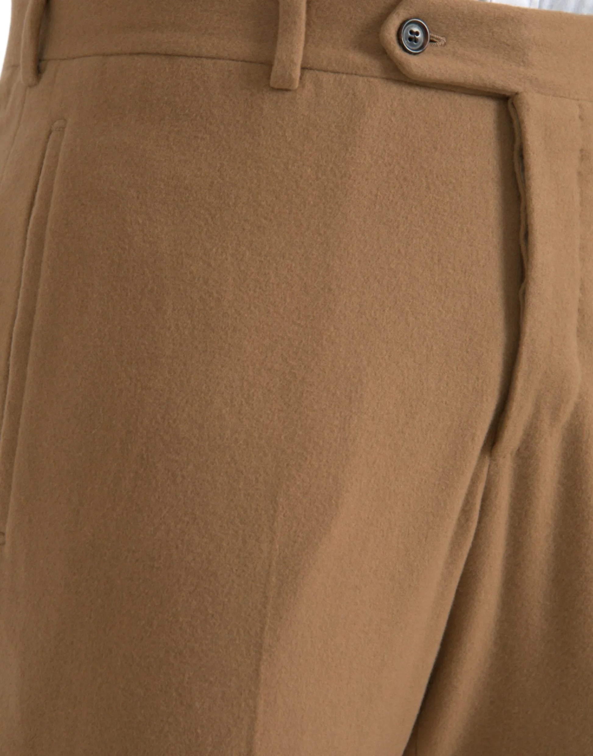 Close-up of tailored camel wool trousers with button detail at ONJEL Fashion Boutique