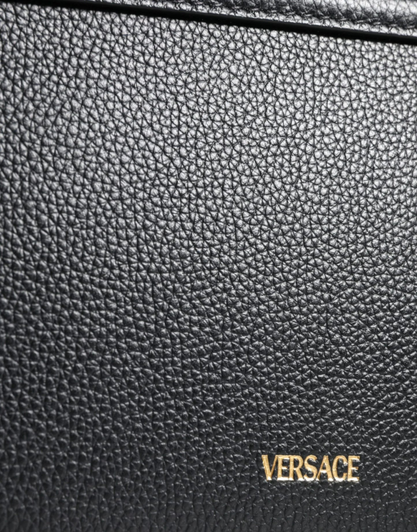 Close-up of black Versace pebbled leather bag with gold logo at ONJEL Fashion Boutique
